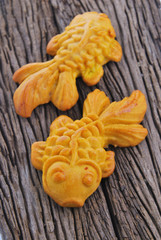 Fototapeta premium Moon cake in gold fish shape or Chinese cake mung bean