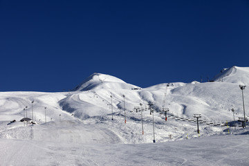 Fototapeta na wymiar Winter mountains and ski slope at sun day