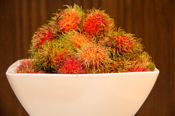  Rambutan in bowle on a wood background.