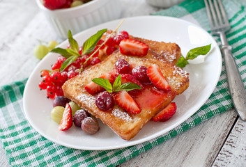 French toast with berries and jam for breakfast