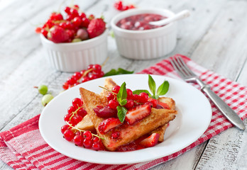 French toast with berries and jam for breakfast