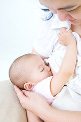 Obraz na płótnie Canvas Asian mother breastfeeding her baby girl