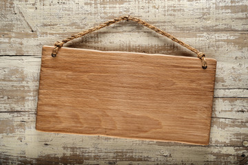 light wood signboard on rustic wooden wall