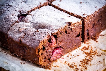 chocolate brownie dessert with cherries closeup