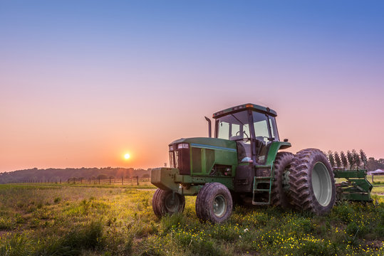 Tractor in a field on a Maryland farm at sunset