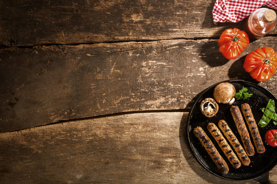Grilled barbecued sausage with mushrooms