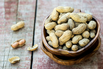 Peanuts in shell pod in bowl
