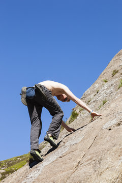 Rock climber climbing solo on Idwal slabs.  Cwm Idwal, Gwynedd, North Wales, UK, Britain, Europe.  