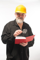 portrait of a man in a construction helmet, a book, a lens