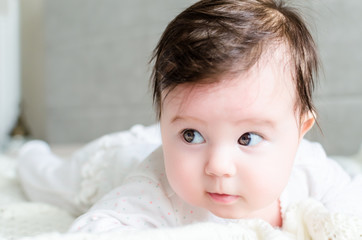 Portrait of cute caucasian little baby girl in backlight