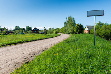 empty road with sign for village name