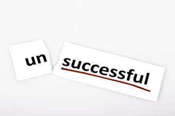 The word unsuccessful changed to successful on torn paper