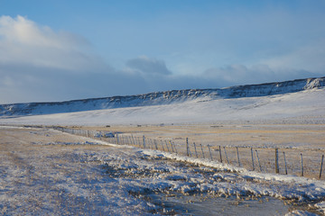 Frozen snow covered fields and mountains during winter in the small village of Cerro Castilla en route to Torres del Paine National Park in Patagonia, Southern Chile