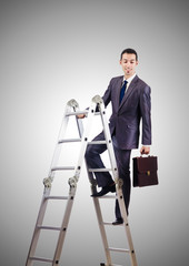 Businessman climbing career ladder against gradient 