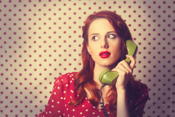 Portrait of a redhead girl with green dial phone
