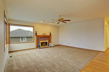 Cpzy unfurnished living room with carpet.