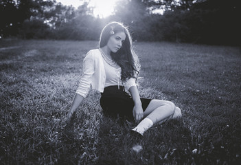 fashion style portrait of young trendy girls at grass