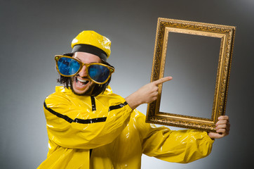 Man wearing yellow suit with picture frame