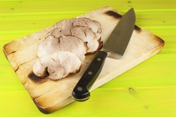 Fototapeta na wymiar Sliced pork roast on a cutting board. Preparing meals for the family. 