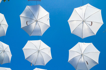 White umbrellas canes in the sky