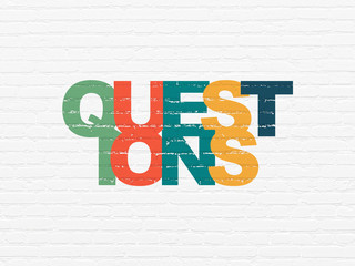 Learning concept: Questions? on wall background