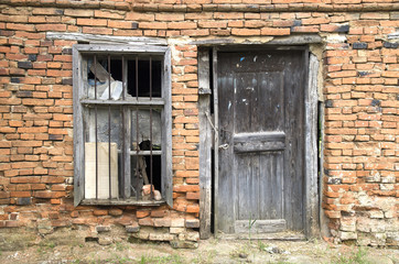 Fototapeta na wymiar Old wooden door and window on abandoned home, Bulgaria