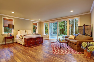 Large master bedroom wth hardwood floor.