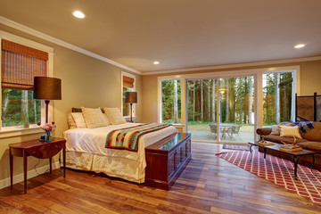Large master bedroom wth hardwood floor.