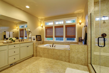 Large master bathroom with tile floor and tub.