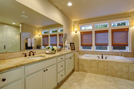 Large master bathroom with tile floor and tub.