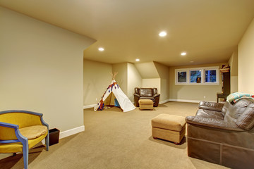Large childrens play room with carpet.