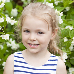 Close up portrait of a six year little girl, against background