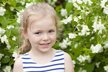 Close up portrait of a six year little girl, against background