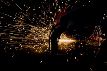 Sparks of bonfire while grinding iron
