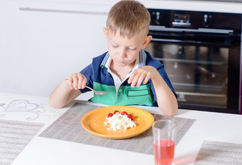 Young Boy Eating Plate of Cheese and Fruit