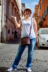 Stylish woman in hat to go in a Rome street 