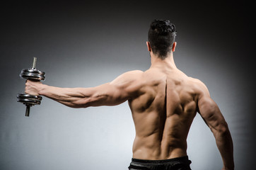 Muscular ripped bodybuilder with dumbbells