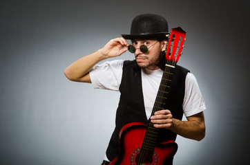 Fototapeta premium Man wearing sunglasses and playing guitar