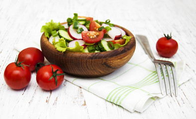 Spring salad with tomato, cucumbers and radish