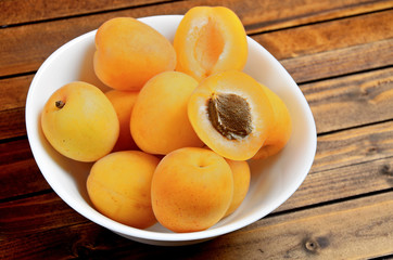 Bowl with apricots fruit on table