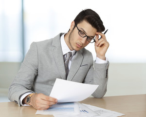 Businessman sitting table and holding document