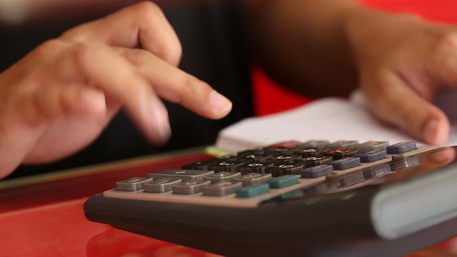 close-up hand of businessman using a calculator