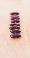 Fototapeta na wymiar Red kidney beans on wooden background