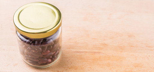 Red kidney beans in mason jar over wooden background