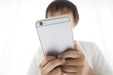 The boy is playing with the latest smartphone
