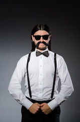 Positive man in classic clothing isolated on gray