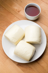Chinese steamed bun with a glass of tea