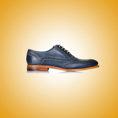 Fashion concept with male shoes against gradient 