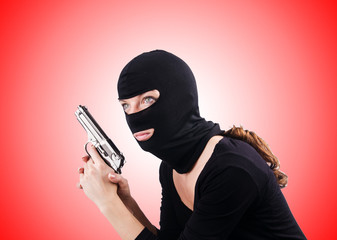 Criminal with gun against the gradient