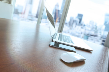 mouse and laptop computer is on wooden desk as workplace concept